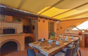 a dining room with a table and a kitchen at Casa Felicina in Massa