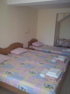 a bedroom with two beds with pink pillows at Guest House Preslav in Nesebar