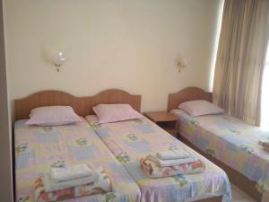 two beds sitting next to each other in a room at Guest House Preslav in Nesebar