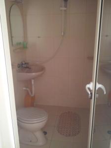 a bathroom with a toilet and a sink at Guest House Preslav in Nesebar