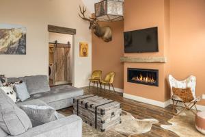 a living room with a couch and a fireplace at Big Pine Chalet in Big Sky