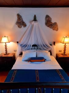 En eller flere senge i et værelse på La Quinta Santa Lucia