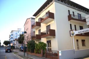 a building with balconies on the side of a street at Villa Carlotta in Lignano Sabbiadoro