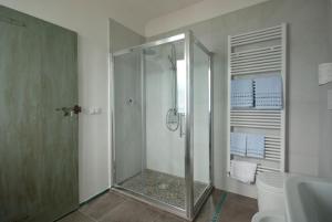 a bathroom with a shower with a glass door at B&B Tre Finestre sul Mare in Grottammare +29 photos