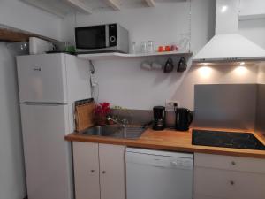 a kitchen with a white refrigerator and a sink at Fisherman's View in Bages