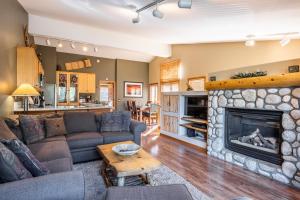 a living room with a couch and a fireplace at Snowcreek V 963 in Mammoth Lakes