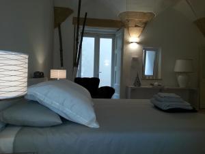 a bedroom with a bed with a pillow and a window at Corte dei Romiti Apartment in Lecce