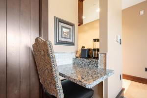 a kitchen with a granite counter top in a room at Arrowleaf Lodge - 1 Bed Studio #111B in Park City
