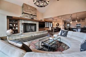a living room with a couch and a fireplace at Powder Haus in Park City