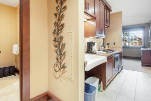 a small kitchen with a sink and a door at Arrowleaf Lodge - 1 Bed Studio #101A in Park City