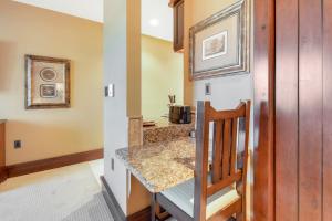 a kitchen with a table and a counter top at Arrowleaf Lodge - 1 Bed Studio #101A in Park City