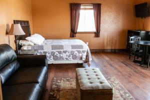 a living room with a bed and a couch at Circle R Motel in East Glacier Park