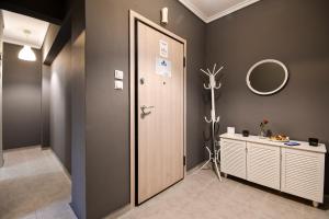 a bathroom with a wooden door and a mirror at Thessaloniki Center Apartment in Thessaloniki +118 photos