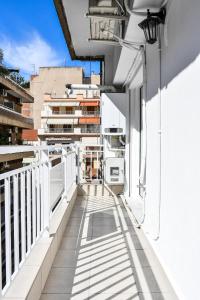 a balcony of a building with a white railing at Thessaloniki Center Apartment in Thessaloniki
