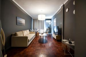 a living room with a couch and a table at Thessaloniki Center Apartment in Thessaloniki