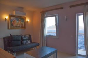a living room with a chair and a window at Sunset Villa Hotel in Kaş