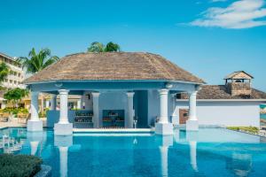 a swimming pool with a gazebo at Iberostar Grand Rose Hall in Montego Bay