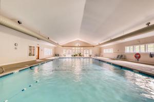 an indoor swimming pool with blue water in a building at Kingswood Retreat in Dover