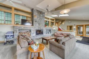 a living room with two couches and a stone fireplace at Kingswood Retreat in Dover