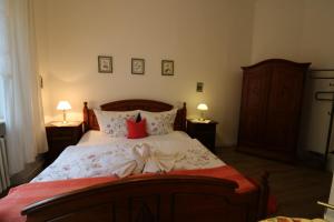 a bedroom with a large bed with red pillows at Villa Amber in Bad Kissingen
