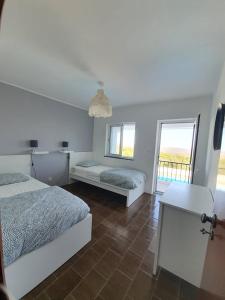 a bedroom with two beds and a window at Casa Baptista in Monchique