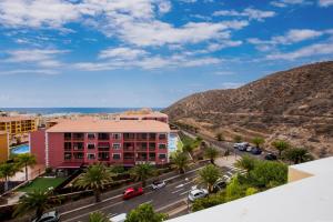 a view of a city with mountains and a building at Palm Mar de LUX A26 in Palm-mar