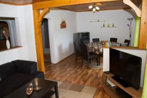 a living room with a television and a dining room at FEWO Wonta am Ossiachersee in Sattendorf