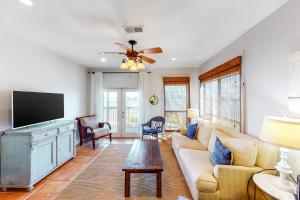 a living room with a couch and a flat screen tv at Molokai Villas 7B in Pensacola