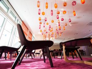 a room with chairs and a chandelier at Motel L Hammarby Sjöstad in Stockholm