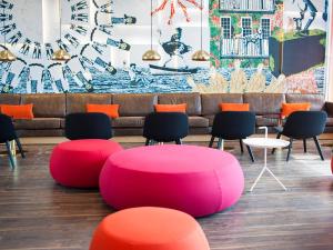 a room with a table and chairs and a couch at Motel L Hammarby Sjöstad in Stockholm