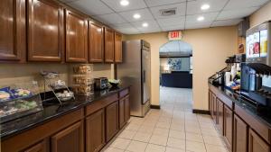 a kitchen with a counter and a refrigerator at SureStay Hotel by Best Western East Brunswick in East Brunswick