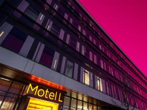 a motel sign on the side of a building at night at Motel L Hammarby Sjöstad in Stockholm