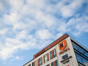 a building with a sign on the top of it at Motel L Hammarby Sjöstad in Stockholm