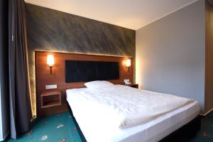 Postel nebo postele na pokoji v ubytování Hotel Freihof