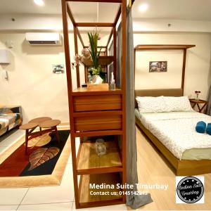 a room with a bunk bed and a room with a bed at Medina Suite Timurbay in Kuantan