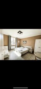 a large bedroom with two beds and a window at Locanda il Deserto in Livorno