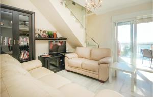 a living room with two chairs and a television at 2 Bedroom Cozy Apartment In Estepona in Estepona