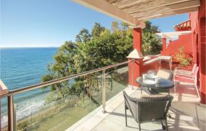 a balcony with a table and chairs and the ocean at 2 Bedroom Cozy Apartment In Estepona in Estepona