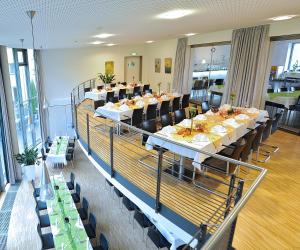 a large dining room with tables and chairs at Hotel und Kongresszentrum Wanderath in Baar