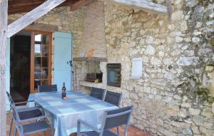 a table and chairs in a stone building with a fireplace at 2 Bedroom Cozy Home In Monestier in Monestier