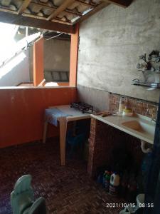 a kitchen with a counter and a sink in a room at SUITE - CIDADE das CACHOEIRAS in Santa Rita de Jacutinga