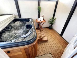eine Whirlpool-Badewanne auf einem Balkon mit Tisch in der Unterkunft Spa pool Treat in Taupo