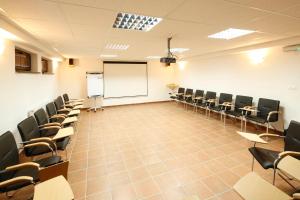 an empty classroom with chairs and a whiteboard at Penzión Kohútik in Oravská Lesná
