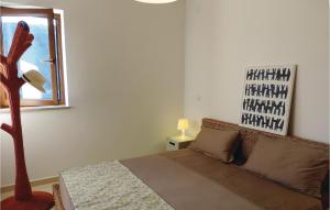 a bedroom with a couch and a window and a table at Lovely Apartment In Labin With Wifi in Labin