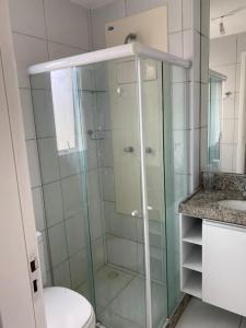 a bathroom with a shower with a toilet and a sink at Muro Alto condomínio clube in Porto De Galinhas