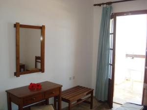 a room with a mirror and a wooden table at Pegasus in Masouri