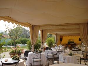 a tent set up for a wedding with tables and chairs at Hotel Barrage in Pinerolo