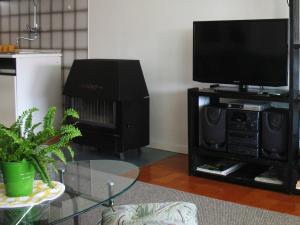 a living room with a flat screen tv and a table at Apartment M in Vodice