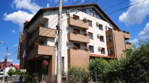 un edificio con flores en los balcones de una calle en Hotel Residenz en Suceava