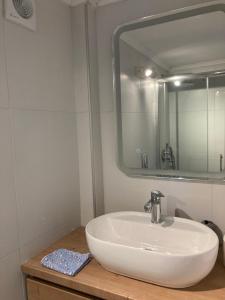 a bathroom with a white sink and a mirror at Sofie's Choice Mytilini Ι in Mytilene